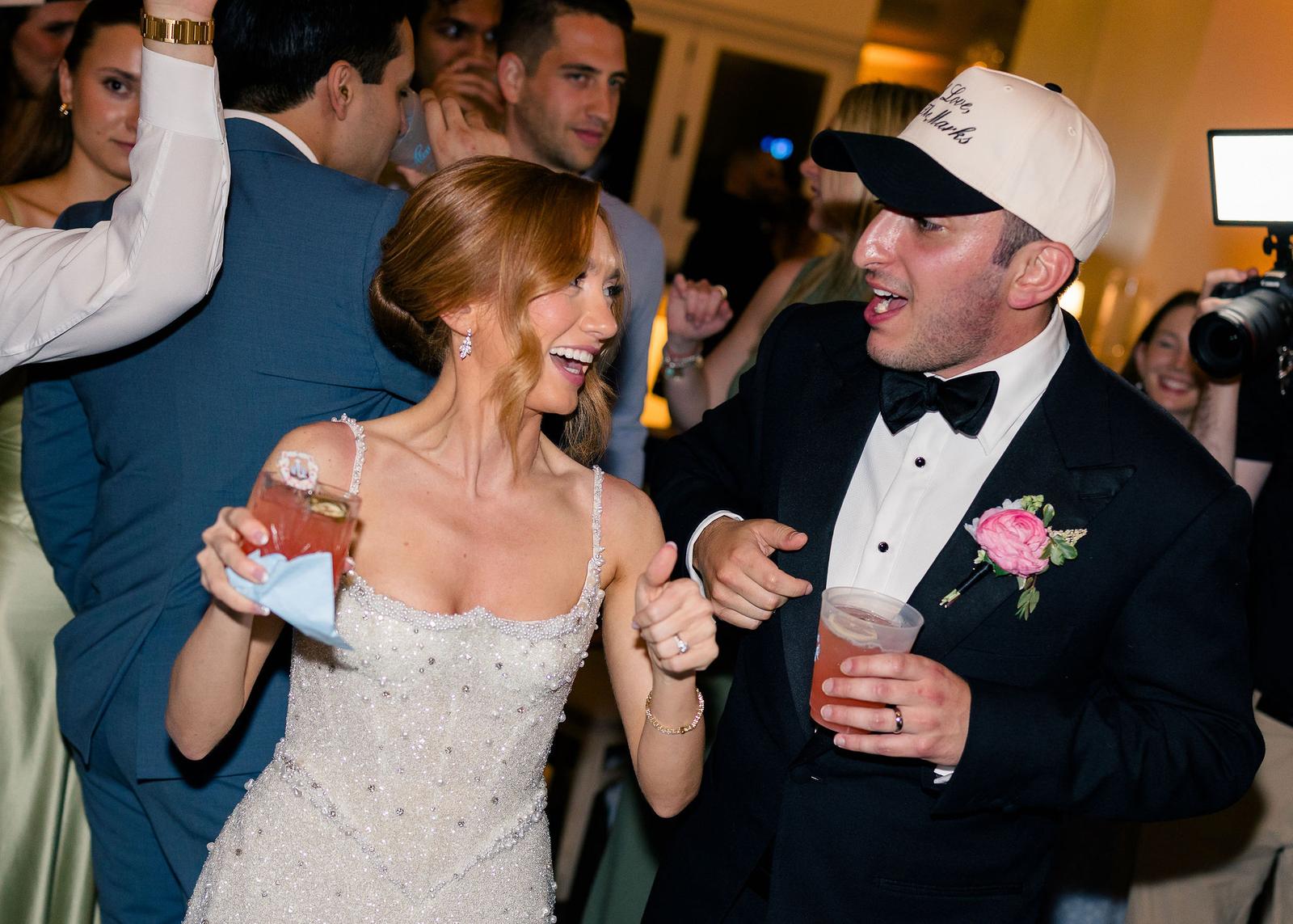 A bride and groom dancing with their guests at a spring garden wedding reception