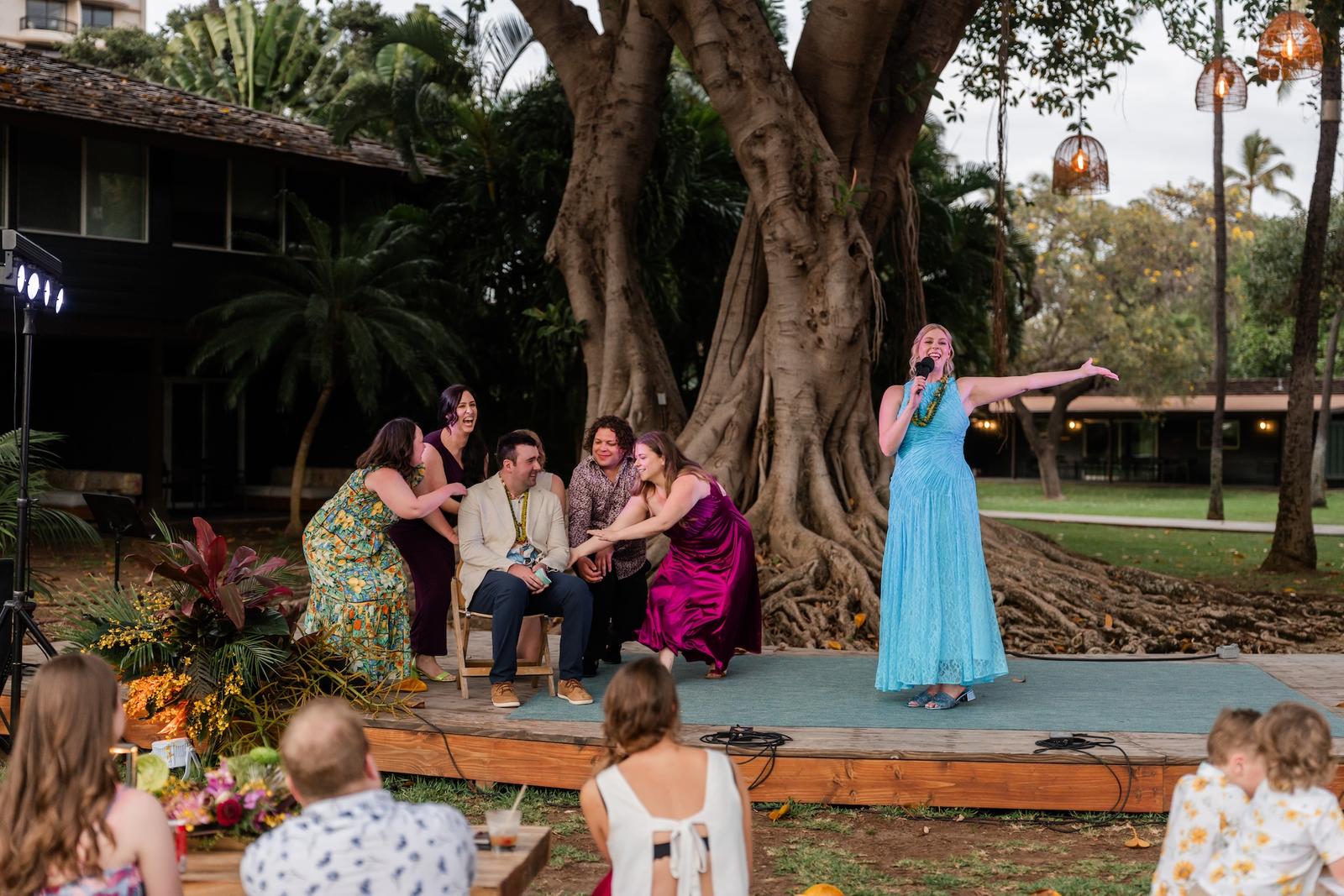 A guest giving a toast at an outdoor welcome event in Maui