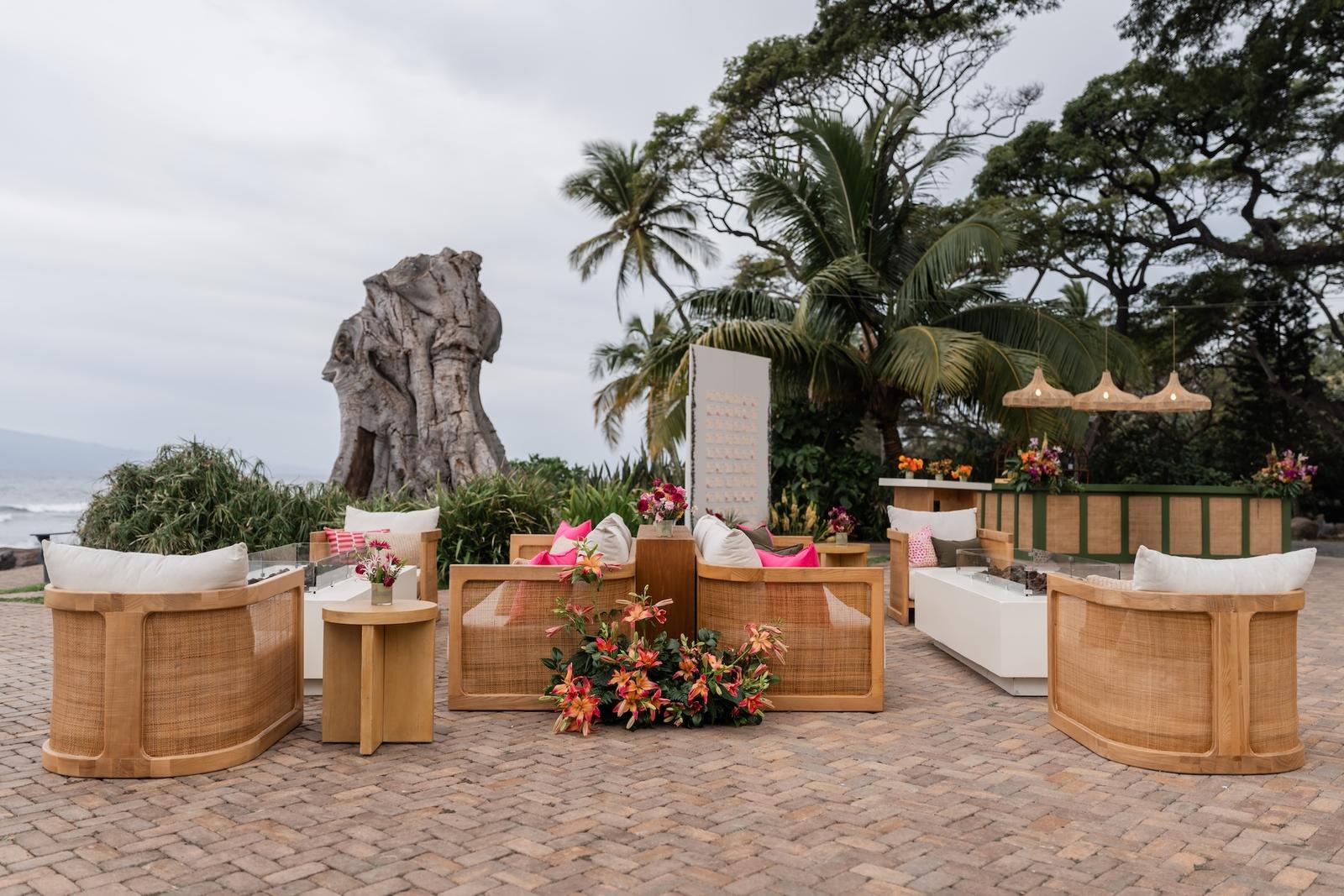 Lounge seating with tropical floral arrangements at a Maui wedding reception