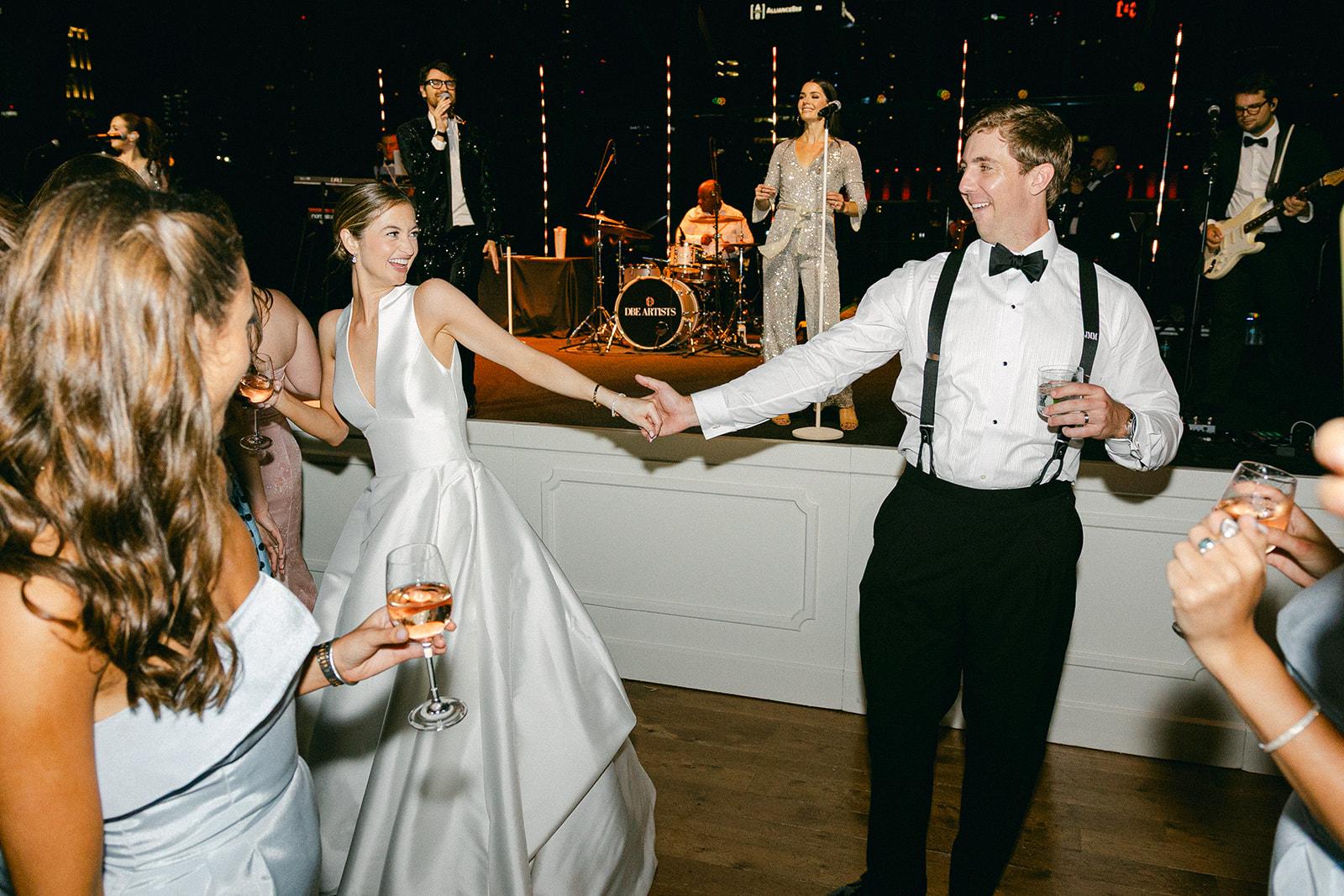 The couple dancing in front of the band