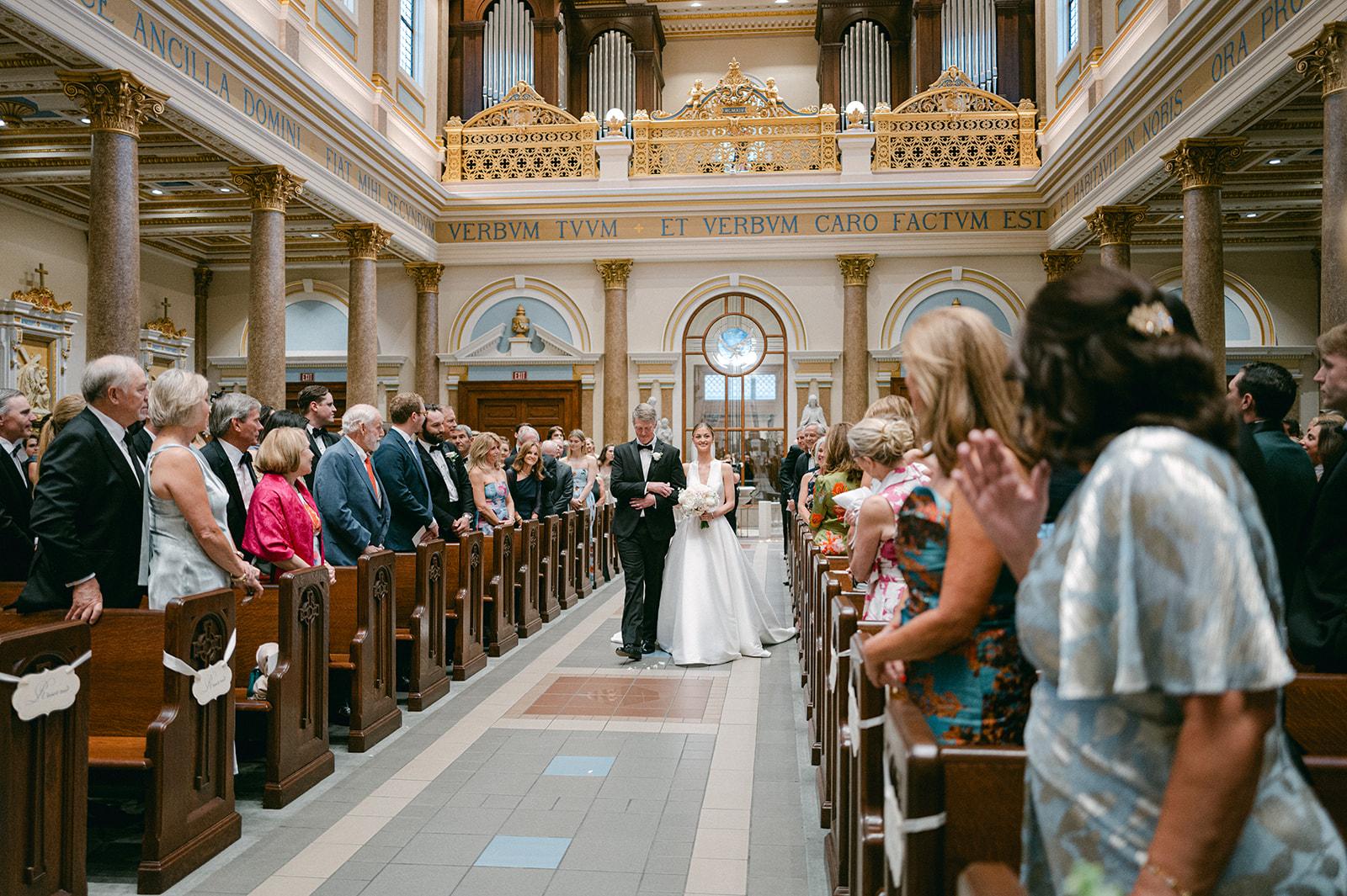 The bride walking down the aisle at the Cathedral of the Incarnation in Nashville