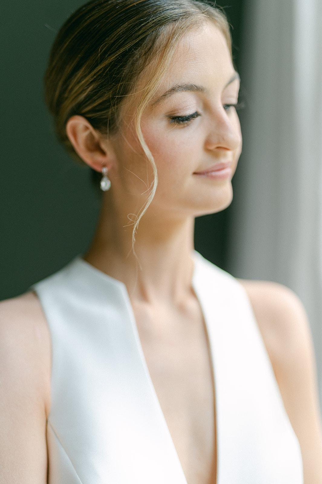 The bride in profile in a white gown