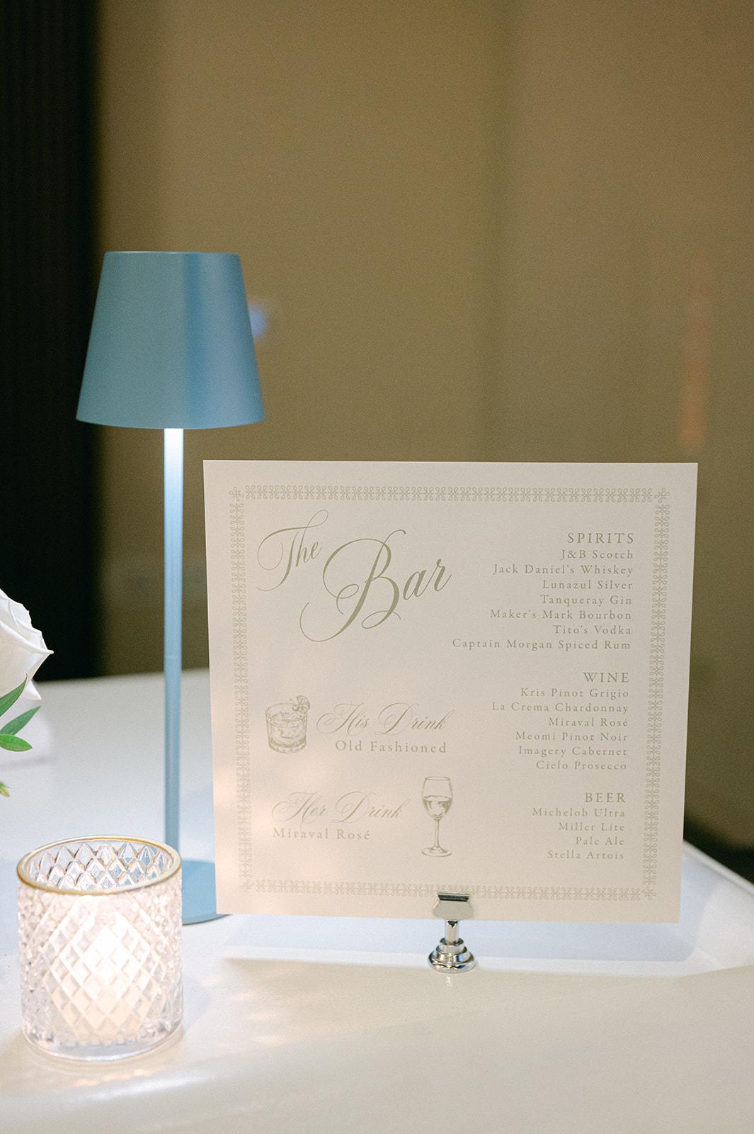 A printed bar menu card beside a blue lamp